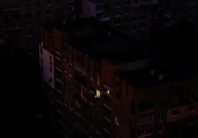 Вікно підсвічується в житловому будинку під час відключень електроенергії, на тлі нападу Росії на Україну, Київ, Україна, 4 вересня 2024 року